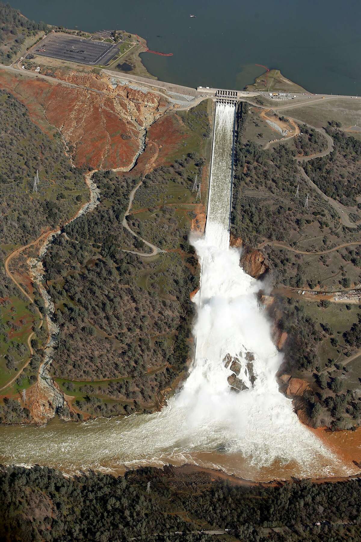 Water flows out of the damaged spillway at Oroville Dam in Oroville, Calif., on Tuesday, February 14, 2017. State water officials say they've met their Nov. 1 deadline for rebuilding the dam's two damaged spillways, but federal officials are skeptical that the repaired spillways can handle a big flood.