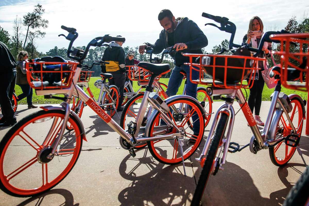 People try out bikes as The Woodlands introduces a new dockless bike sharing program, MoBike, at Town Green Park Friday, Jan. 5, 2018. The bikes don't need to be returned to a specific location at the end of a users ride and can be unlocked by a new user with phone app. ( Michael Ciaglo / Houston Chronicle)
