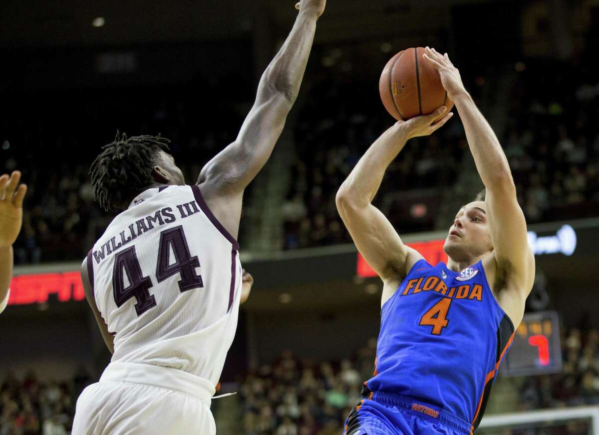 Florida guard Egor Koulechov (4) puts up a shot against Texas A&M forward Robert Williams (44) during the second half of an NCAA college basketball game Tuesday, Jan. 2, 2018, in College Station, Texas. Florida won, 83-66.