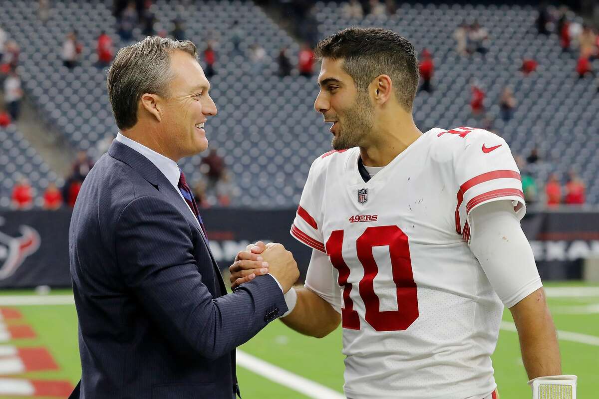 FILE -- Jimmy Garoppolo #10 of the San Francisco 49ers celebrates with general manager John Lynch after the game against the Houston Texans at NRG Stadium on December 10, 2017 in Houston, Texas. A story in The Ringer discussed the moment when Garoppolo eventually won over 49ers head coach Kyle Shanahan.