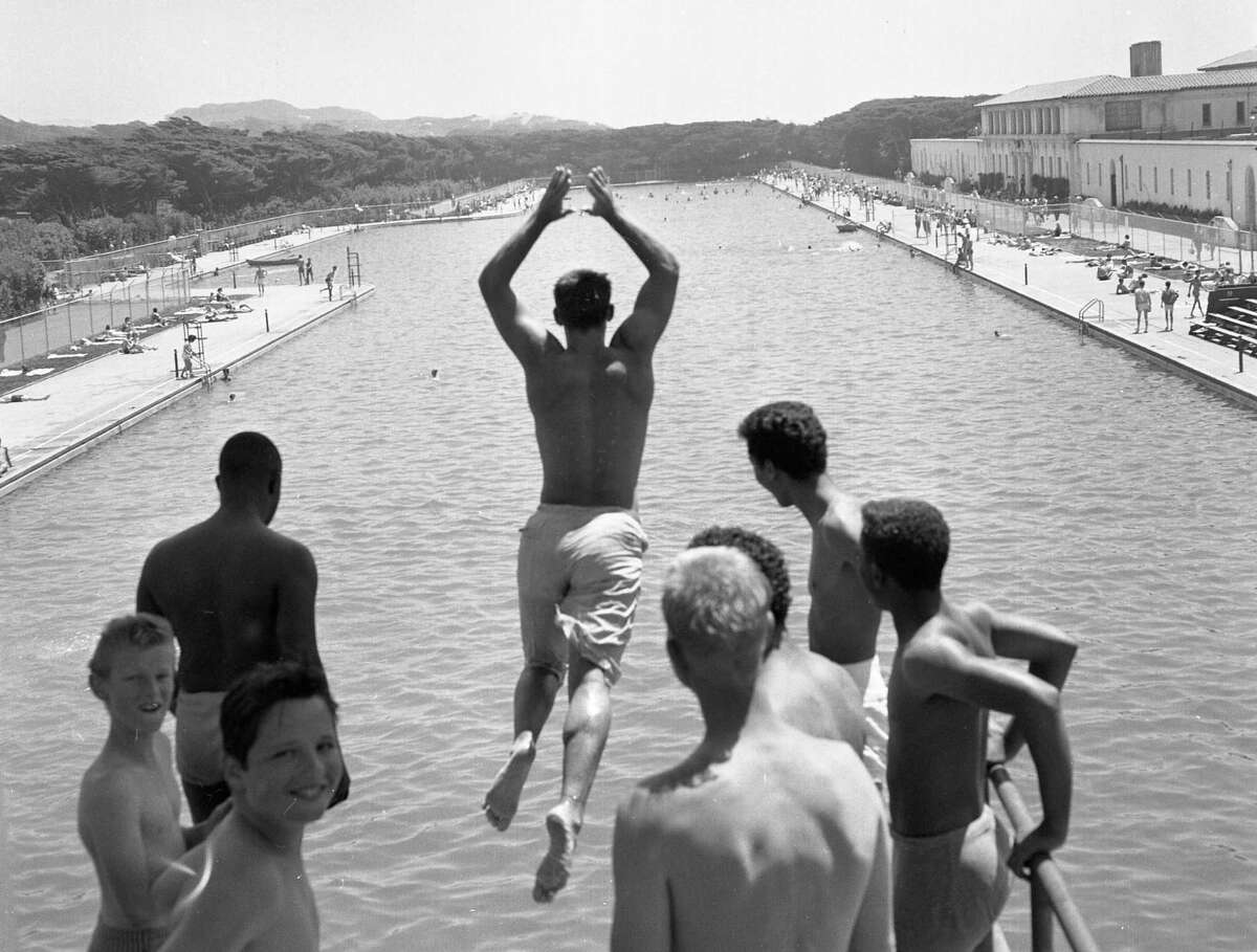 Young people jump off the high-diving platform at Fleishhacker Pool in July 1961.
