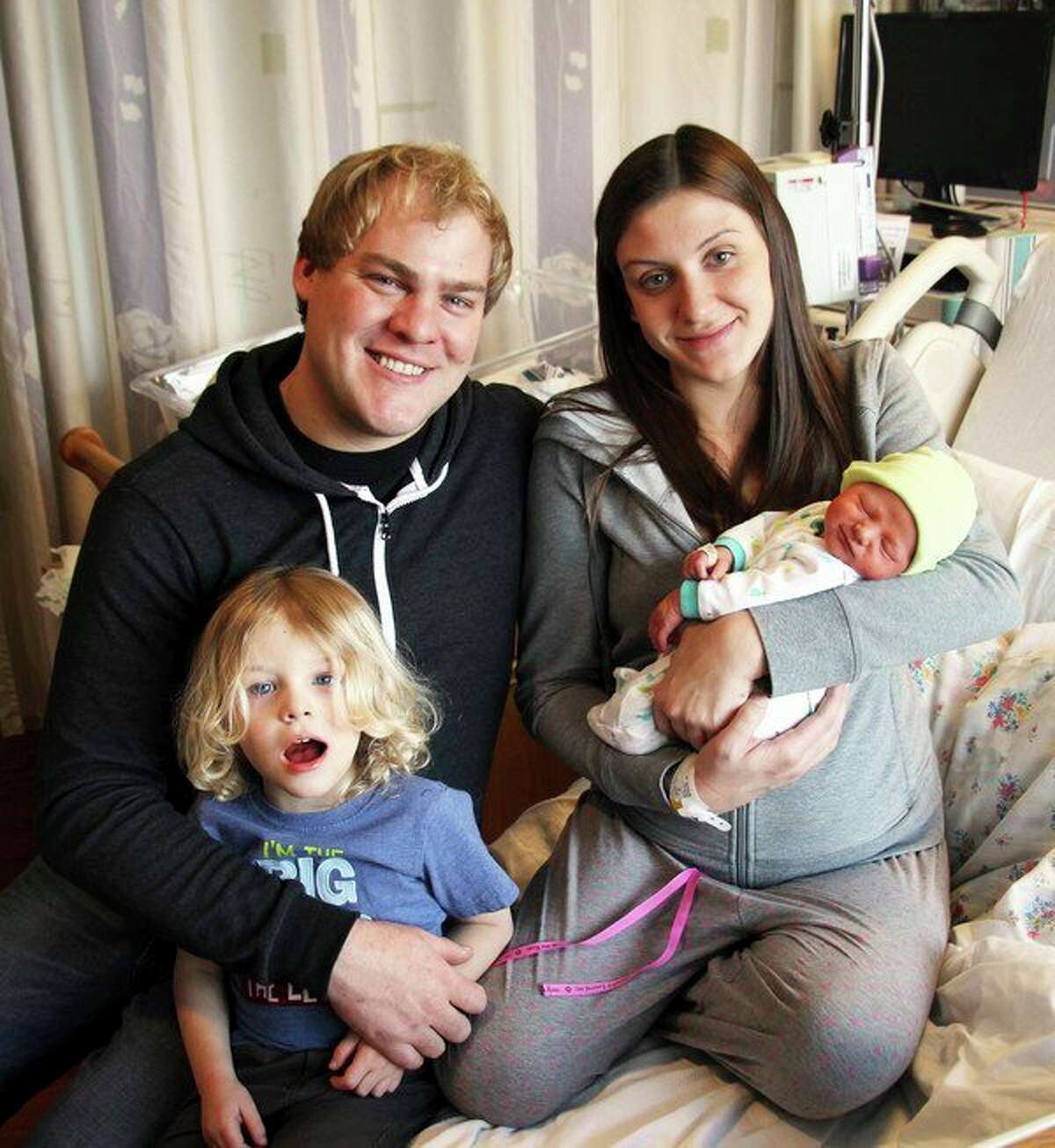 Rowan James Kretzschmer was the first baby born in Huron County in 2018. He is pictured with his father Wesley, mother Emily and brother Asher. 