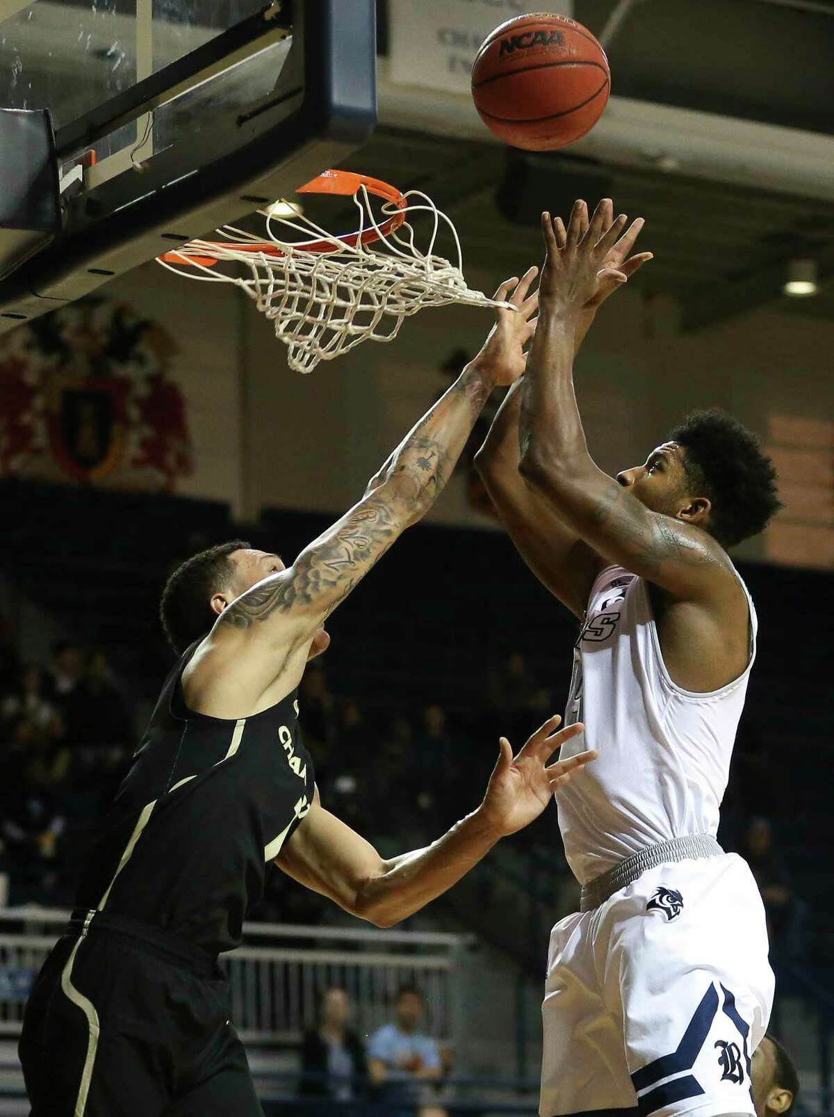 Rice Owls guard Bishop Mency (15) beats Charlotte 49ers forward Najee Garvin (1) to put the ball into the basket during the first quarter of the NCAA game at Tudor Field House on Saturday, Jan. 6, 2018, in Houston.