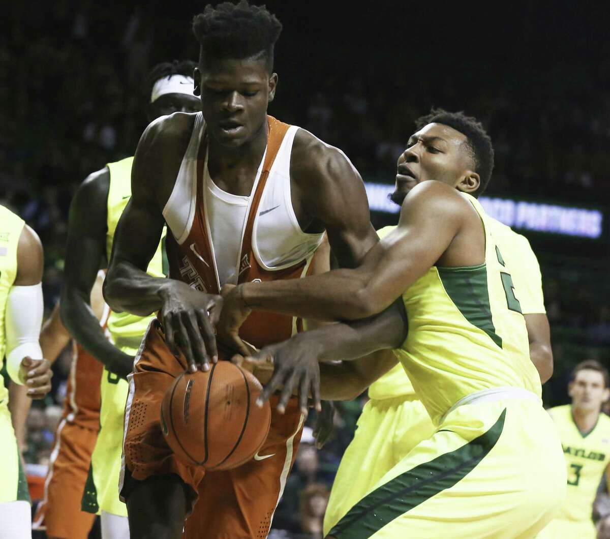 Texas forward Mohamed Bamba, left, reaches for a loose rebound with Baylor guard King McClure, right, in the first half of an NCAA college basketball game, Saturday, Jan. 6, 2018, in Waco, Texas. (Rod Aydelotte/Waco Tribune Herald via AP)