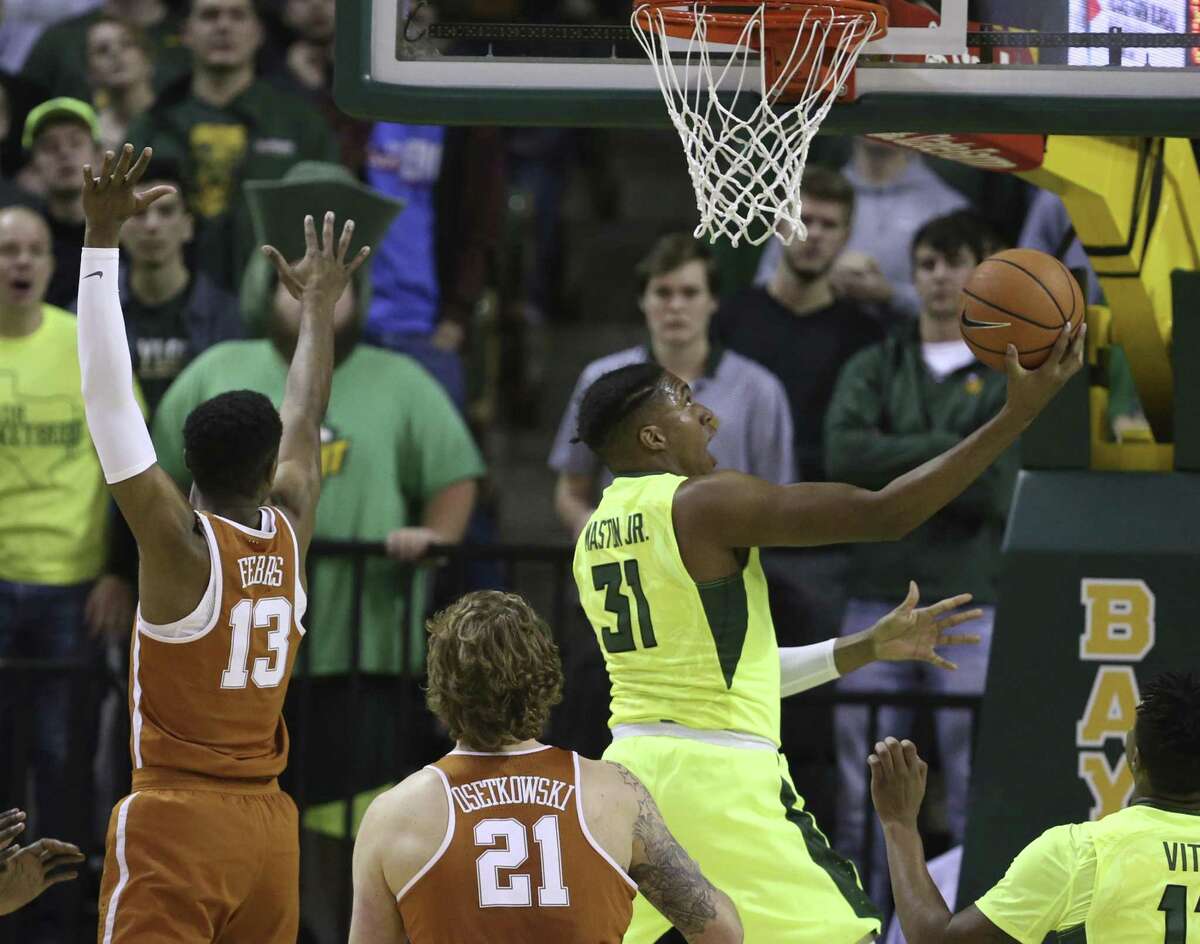 Baylor forward Terry Maston, right, scores past Texas guard Jase Febres, left, in the first half Saturday in Waco. Baylor won 69-60.