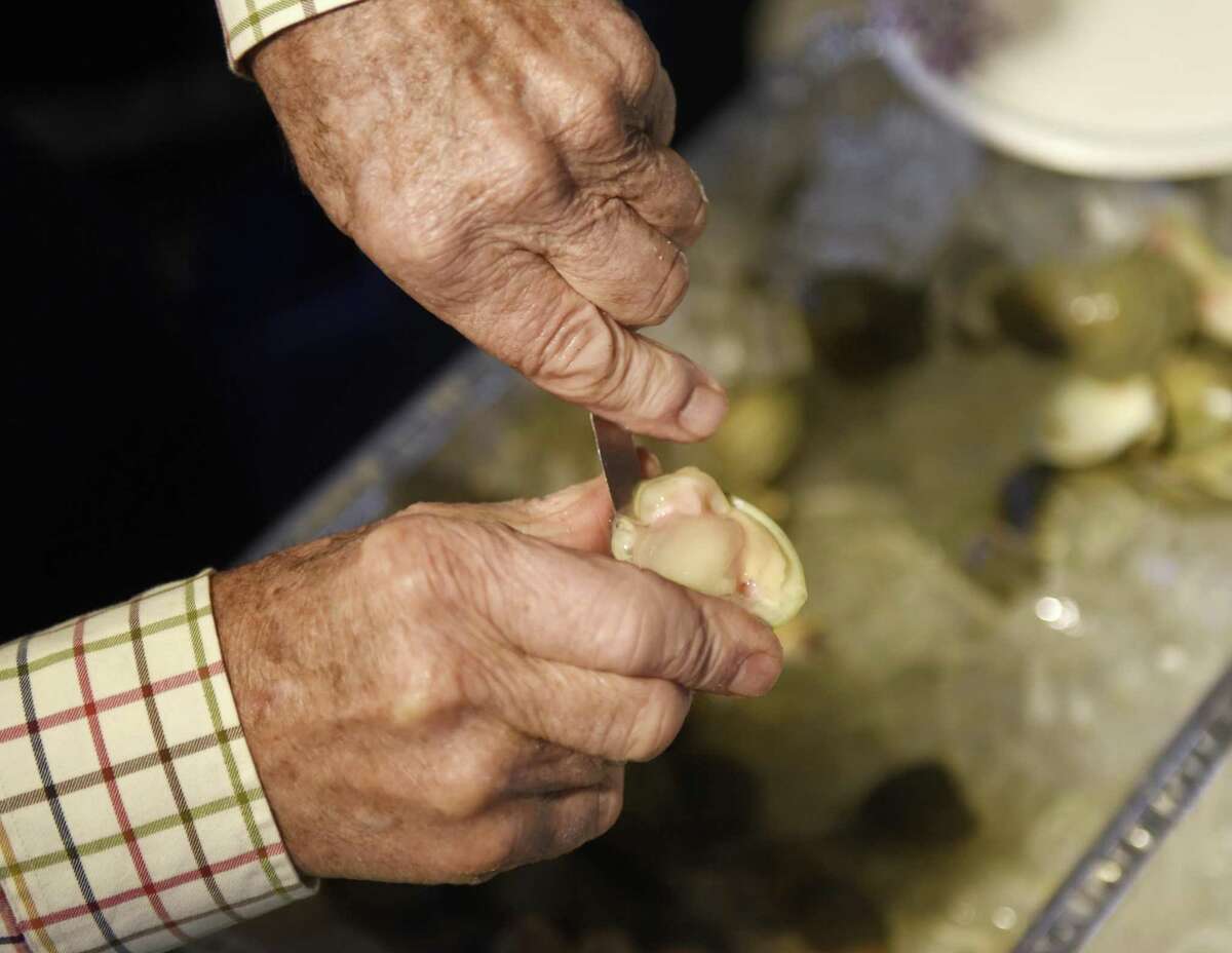 Atlantic Clam Farms owner Ed Stilwagen shucks a clam at Greenwich Point Park's Innis Arden Cottage in Old Greenwich, Conn. Sunday, Jan. 7, 2018. Shellfish Commission leaders and local shellfishermen gave a presentation on the status of shellfish in the Long Island Sound, followed by a presentation of creative cooking ideas for shellfish by Mill Street Bar & Table Managing Partner and Executive Chef Geoff Lazlo.