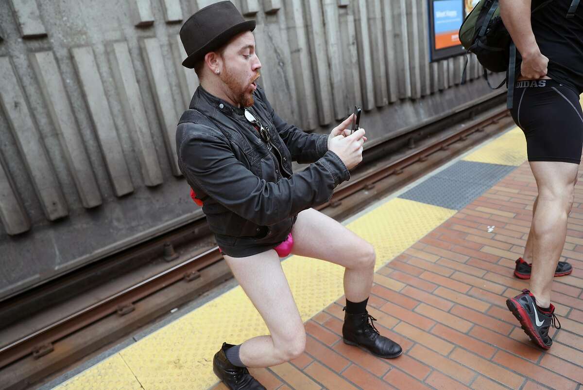 Larry Lane takes a photo of a fellow No Pants! Subway Ride 2018 participant at BART Balboa station in San Francisco, Calif., on Sunday, January 7, 2018.