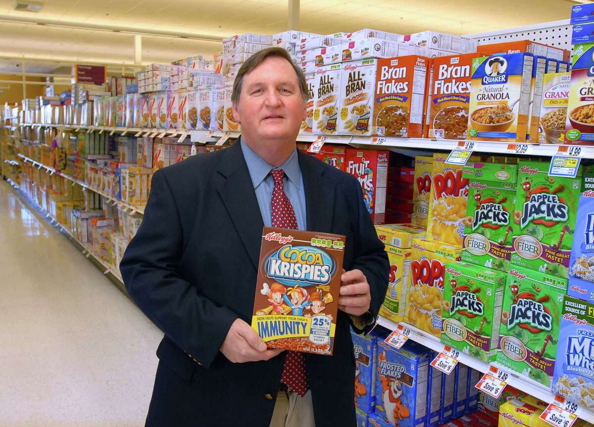 Cas091222 12/22/09 Amity-- Kelly Brownell, director of the Rudd Center for Food Policy and obesity at Yale, shows off one of the worst offenders of sugary cereal targeted at children. Photos -Peter Casolino/New Haven Register ***SEE STORY