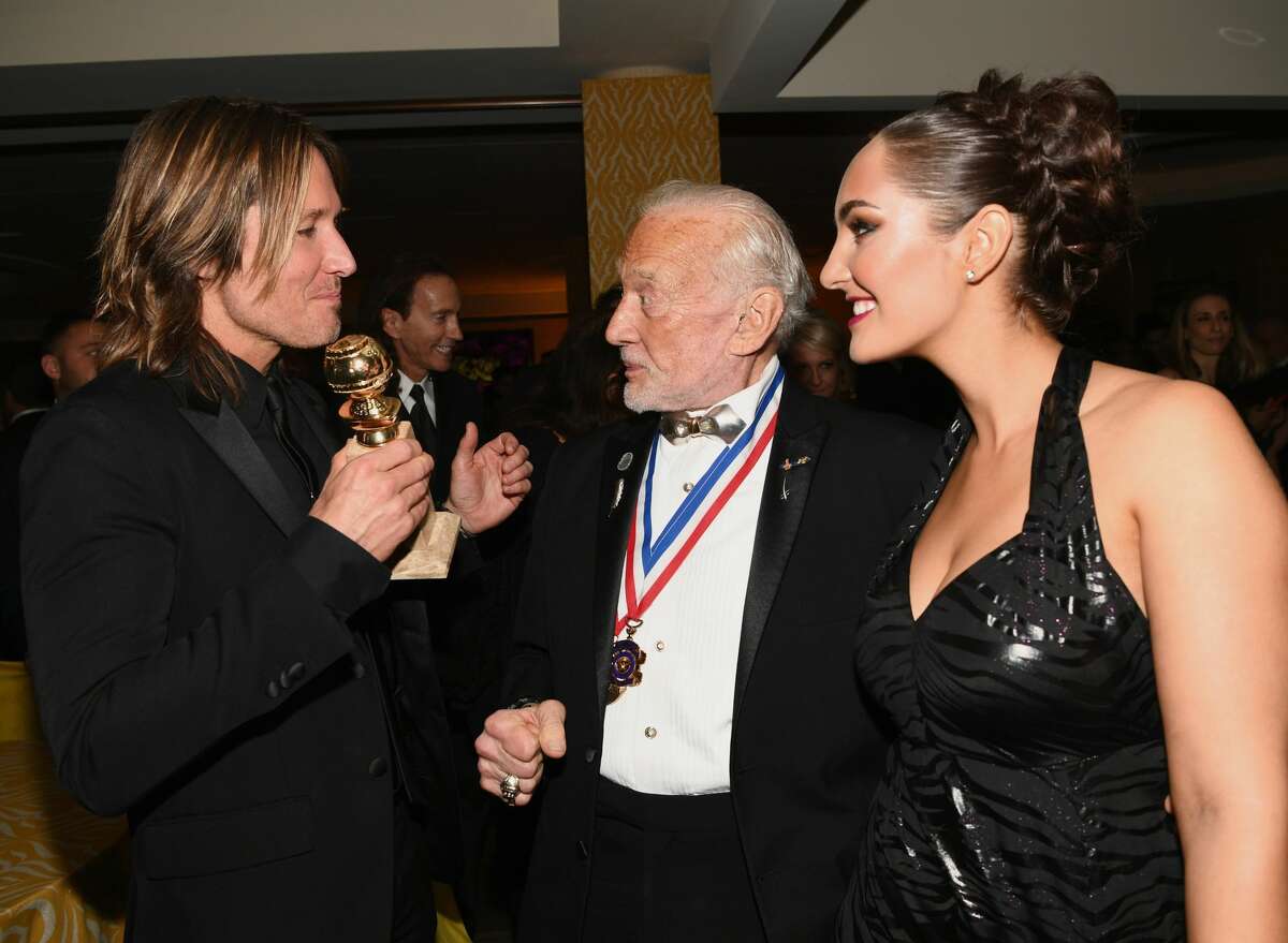 FILE - (L-R) Singer Keith Urban, astronaut Buzz Aldrin and guest attend HBO's Official Golden Globe Awards After Party at Circa 55 Restaurant on Jan. 7, 2018 in Los Angeles, Calif. Aldrin, a former astronaut, is endorsing Republican contender Dan Crenshaw to replace Rep. Ted Poe, R-Texas.