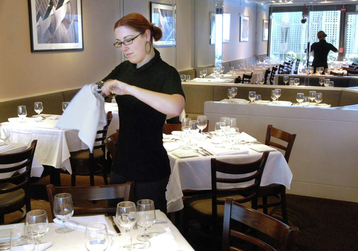 NE12/23/08 1Scoozzi ML0505E Jennifer Walsh, manager of Scoozzi Trattoria and Wine Bar in New Haven, in the main dining room prepping for lunch. Photo by Mara Lavitt
