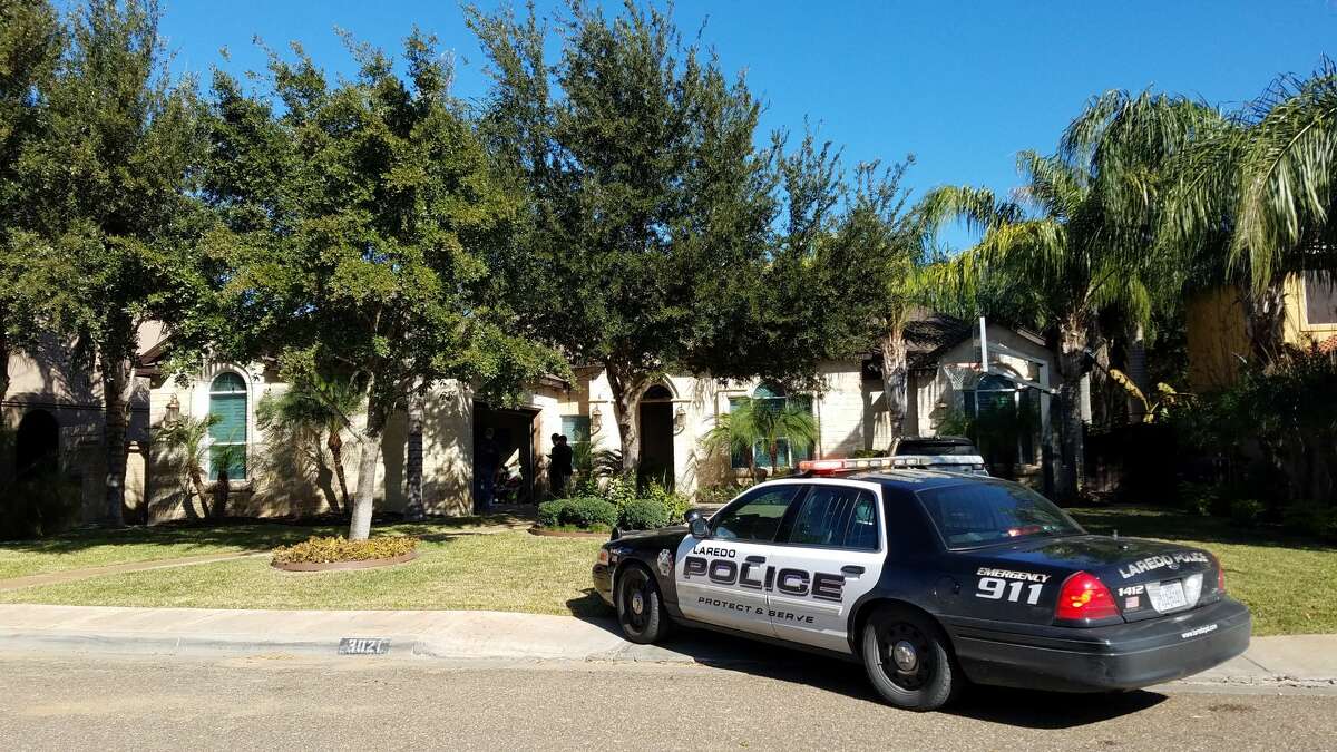 A Laredo police unit is shown outside a home in the 3000 block of Robert Frost on Friday afternoon. Authorities said they executed a search warrant at the home in connection with an illegal gambling investigation. The property is owned by Joel Lopez, head coach of the Alexander High School football team.