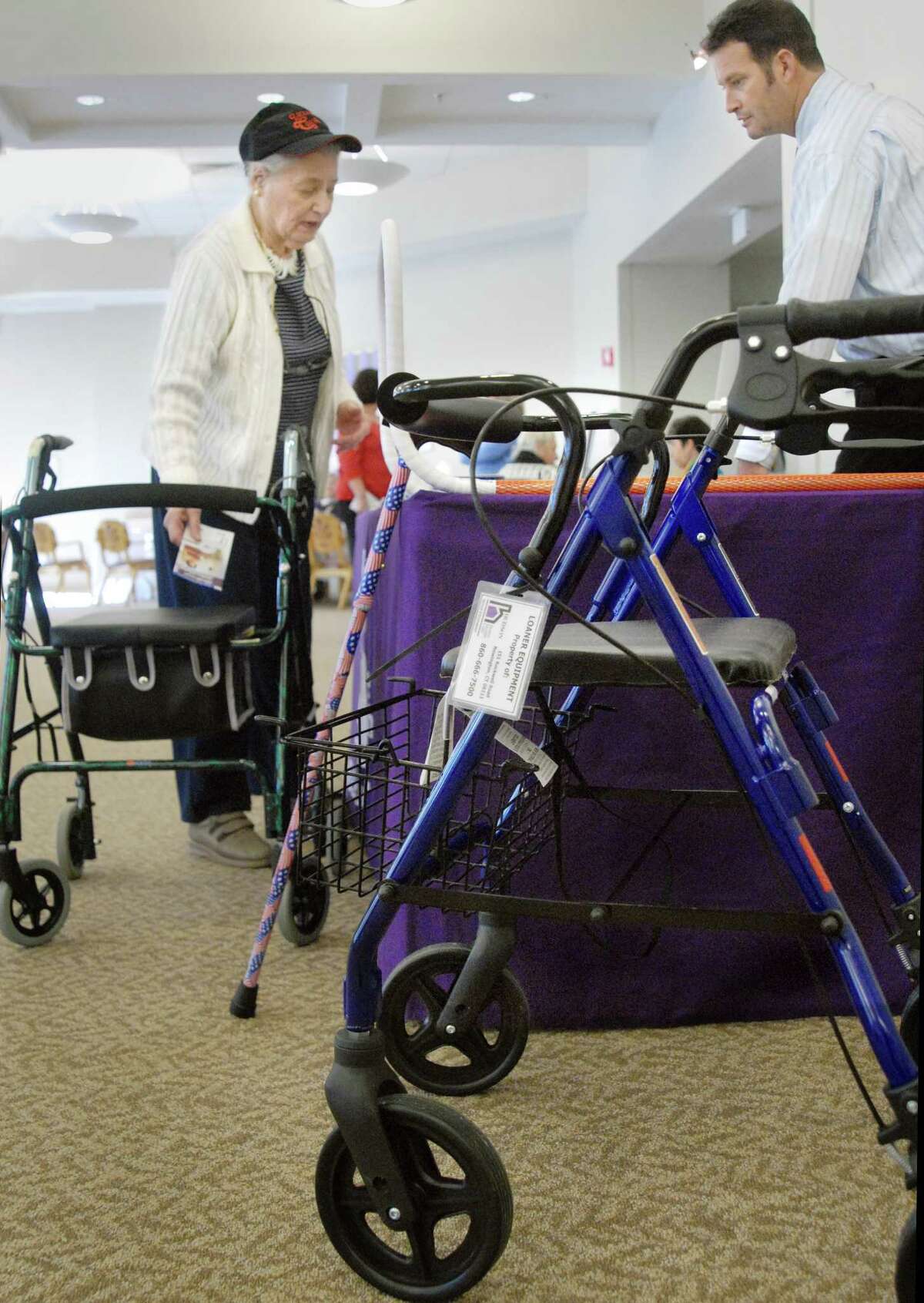 (ms011409)-Helen Z. Kaplan, of New Haven, takes some informatin from Greg Sce, of Hudson Home Health Care, during the Safety fair at Tower One East in New Haven. Melanie Stengel/Register