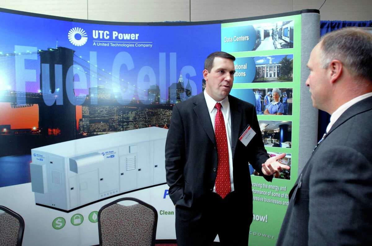 Erik Robie (left), regional sales manager for UTC Power, talks with Michael Thibault, sales engineer for the Power Systems division of H.O. Penn Machinery Co., at What's the Deal? X Business Energy Conference held in Cromwell on 10/14/2009. Photo by Arnold Gold AG0336F