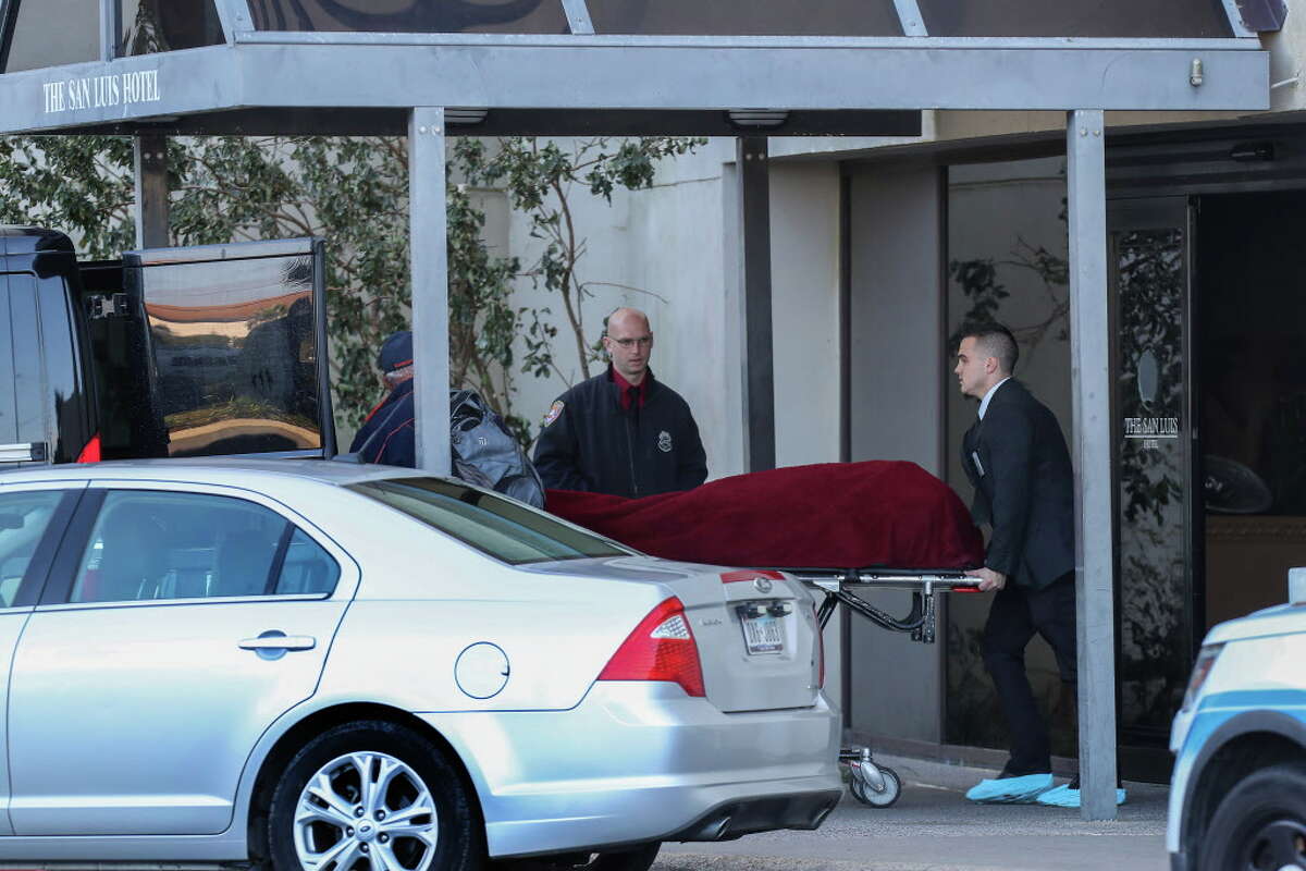 Officials remove one of three dead persons from the San Luis Resort Monday, Jan. 8, 2018, in Galveston. Three people are dead and another is critically wounded after what police are describing as an apparent murder-suicide at a Galveston resort hotel. Galveston police responded to a 911 call around 4:30 a.m. Monday after a hotel guest at the San Luis Resort reported hearing "pops" coming from a nearby room, said Galveston Police Department spokesman Joshua Schirard.