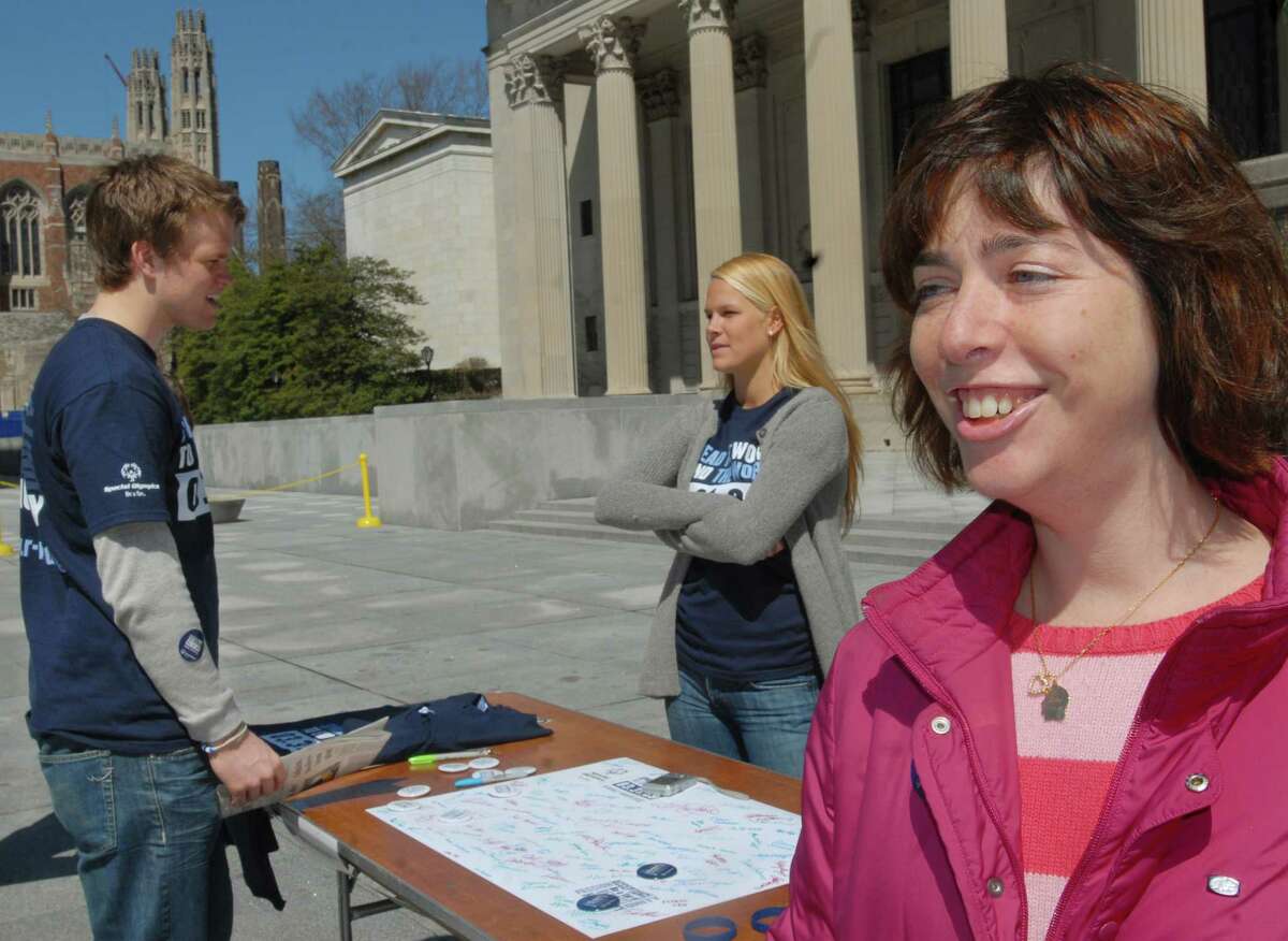 (ms033109)-Special Olympian, Betsy Katz, of New Haven (R) talks about her feelings as a person with a disability. She is at Beineke Plaza with Yale students, Tim Shriver Jr. (L) and Christina White. Melanie Stengel/Register