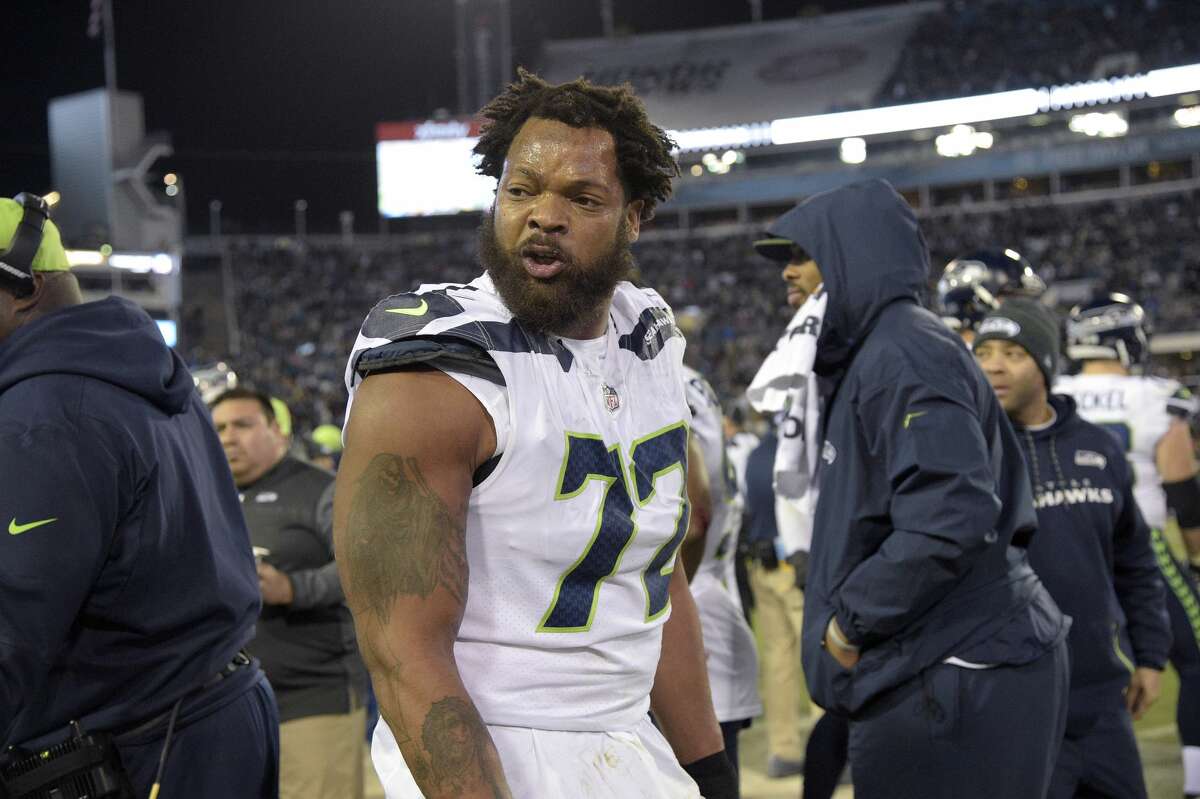 Seattle Seahawks defensive end Michael Bennett (72) argues with teammate defensive end Marcus Smith on the sideline during the second half of an NFL football game against the Jacksonville Jaguars Sunday, Dec. 10, 2017, in Jacksonville, Fla. The Jaguars won 30-24. (AP Photo/Phelan M. Ebenhack)