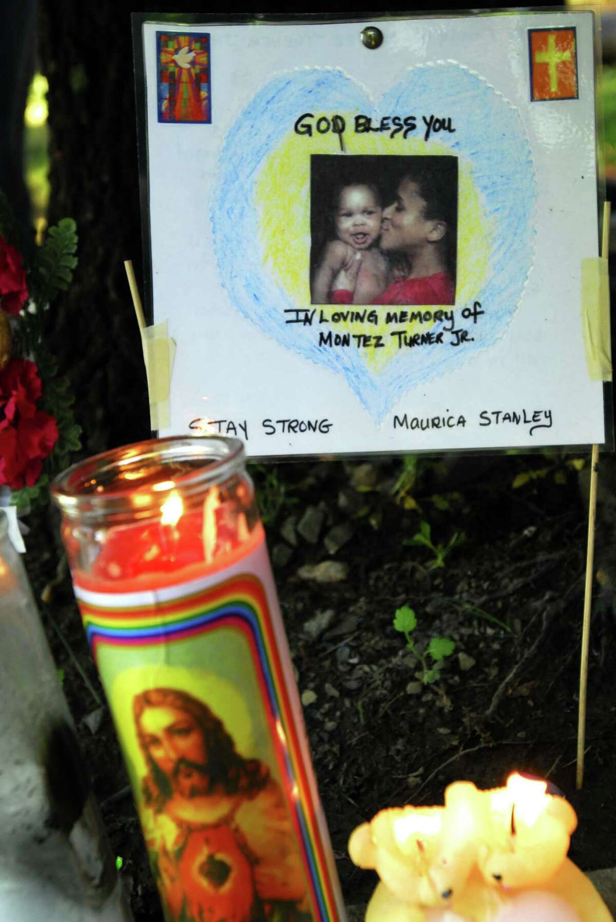 Photography by PETER HVIZDAK ph1077 #3487 New Haven, Connecticut- June 12, 2009: Sign with photo of Montez Turner Jr., a 17-month-old baby and his mother Mauricia Stanley, 17, at a makeshift memorial during a candlelight vigil Friday night at the scene of the hit-and-run crash on Mansfield and Division streets that killed Turner and left Stanley critically injured.