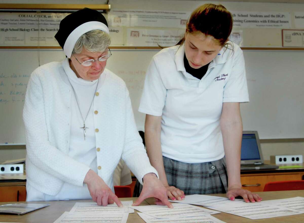 (ms051507)-Sister Mary Jave Paolella (L) and sacred Heart senior, Nicole Perrelli, look over gene sequences . Melanie Stengel/Register