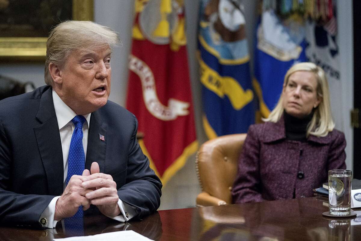 FILE- In this Thursday, Jan. 4, 2018, file photo, President Donald Trump, accompanied by Secretary of Homeland Security Kirstjen Nielsen, right, speaks during a meeting with Republican Senators on immigration in the Roosevelt Room at the White House in Washington. The Trump administration faces a Monday, Jan. 7, deadline on whether to extend protections that would allow nearly 200,000 Salvadorans to stay in the U.S. legally. Nielsen, who is tasked with making the decision, told the Associated Press last week that short-term extensions are not the answer. (AP Photo/Andrew Harnik, File)