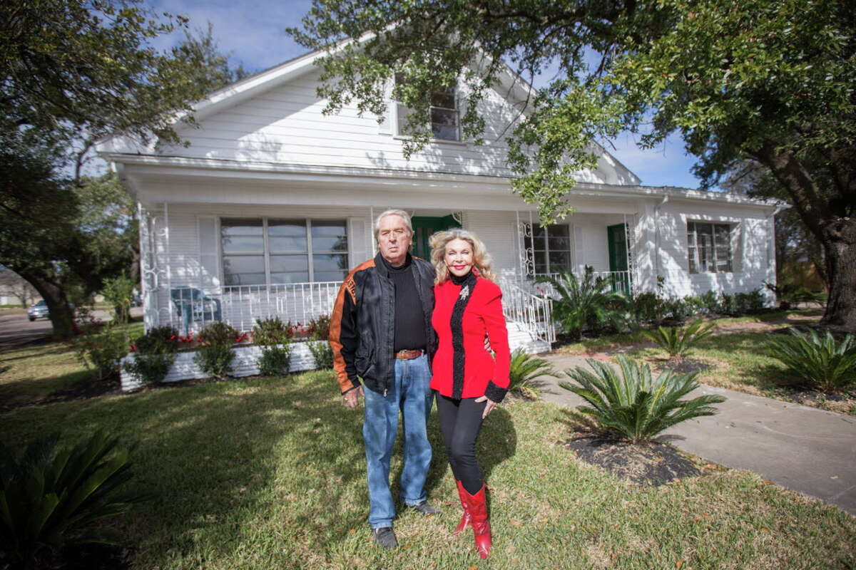 Carl and Lyn Howard pose for a portrait in front of the historic Isaac Conroe house on Friday. The Howards purchased the home in October and are in the process of restoring it. They'd like to see the home eventually become a museum for the city of Conroe.