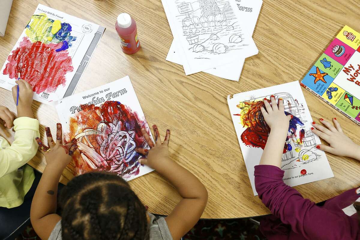 Ann Marie Becerra, 3, (from left), Zuri Sturdivant, 2, and Emma Summers, 7, paint while staying at the Lil' Roadrunners Children's Evening program Monday Jan. 8, 2018 at La Trinidad United Methodist Church.