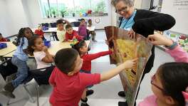 Art teacher Carolyn Jackson﻿ showcases a picture of Gustav Klimt's "The Kiss" painting to a kindergarten class at Robinson Elementary on Monday﻿. About 550 students returned to their home campus after it was flooded during Hurricane Harvey.﻿﻿