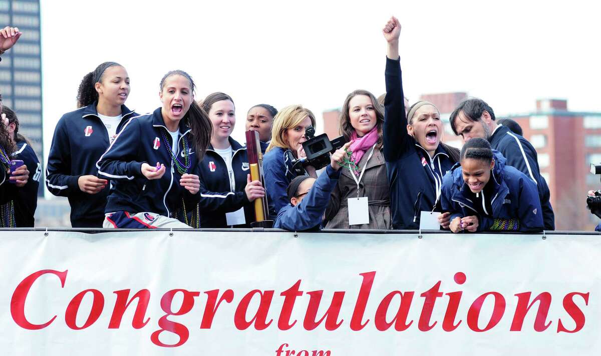 The UCONN women's 2013 NCAA championship basketball team celebrates on top of a double decker bus during a parade through downtown Hartford on 4/14/2013. Photo by Arnold Gold/New Haven Register