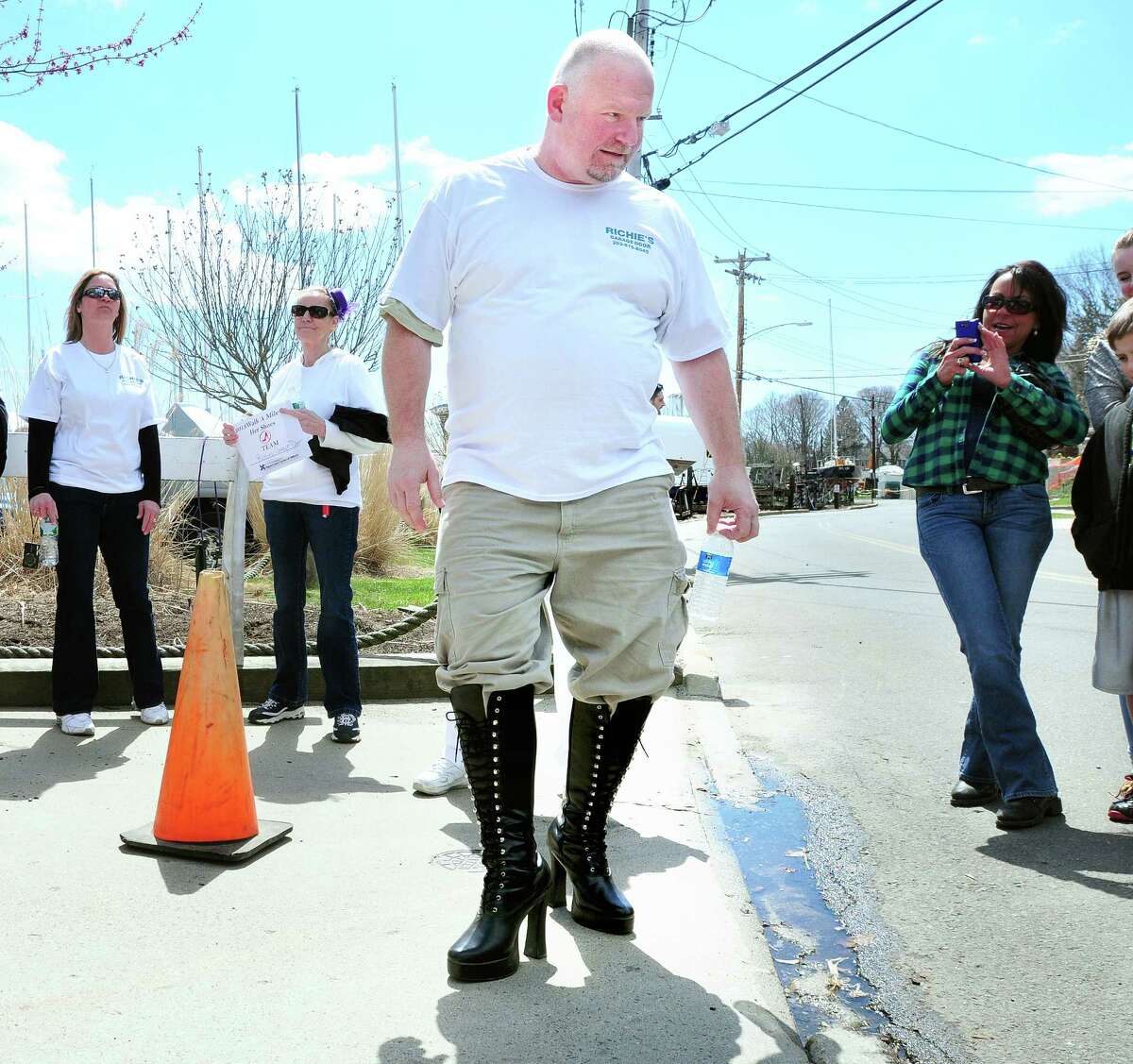 Tom Duggan of Milford shows off his black boots before the start of the 7th annual Walk A Mile In Her Shoes: The Men's March to Stop Rape, Sexual Assault & Gender Violence in Milford on 4/14/2013. Photo by Arnold Gold/New Haven Register AG0492E