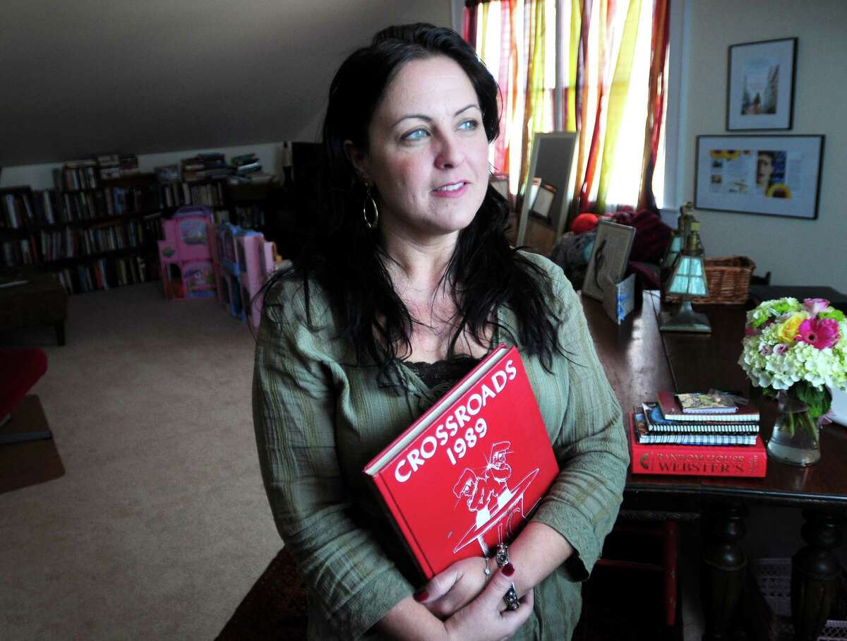 Author Suzanne Palmieri is photographed with her Wilbur Cross High School yearbook at her home in New Haven on 4/2/2013. Photo by Arnold Gold/New Haven Register AG0490B