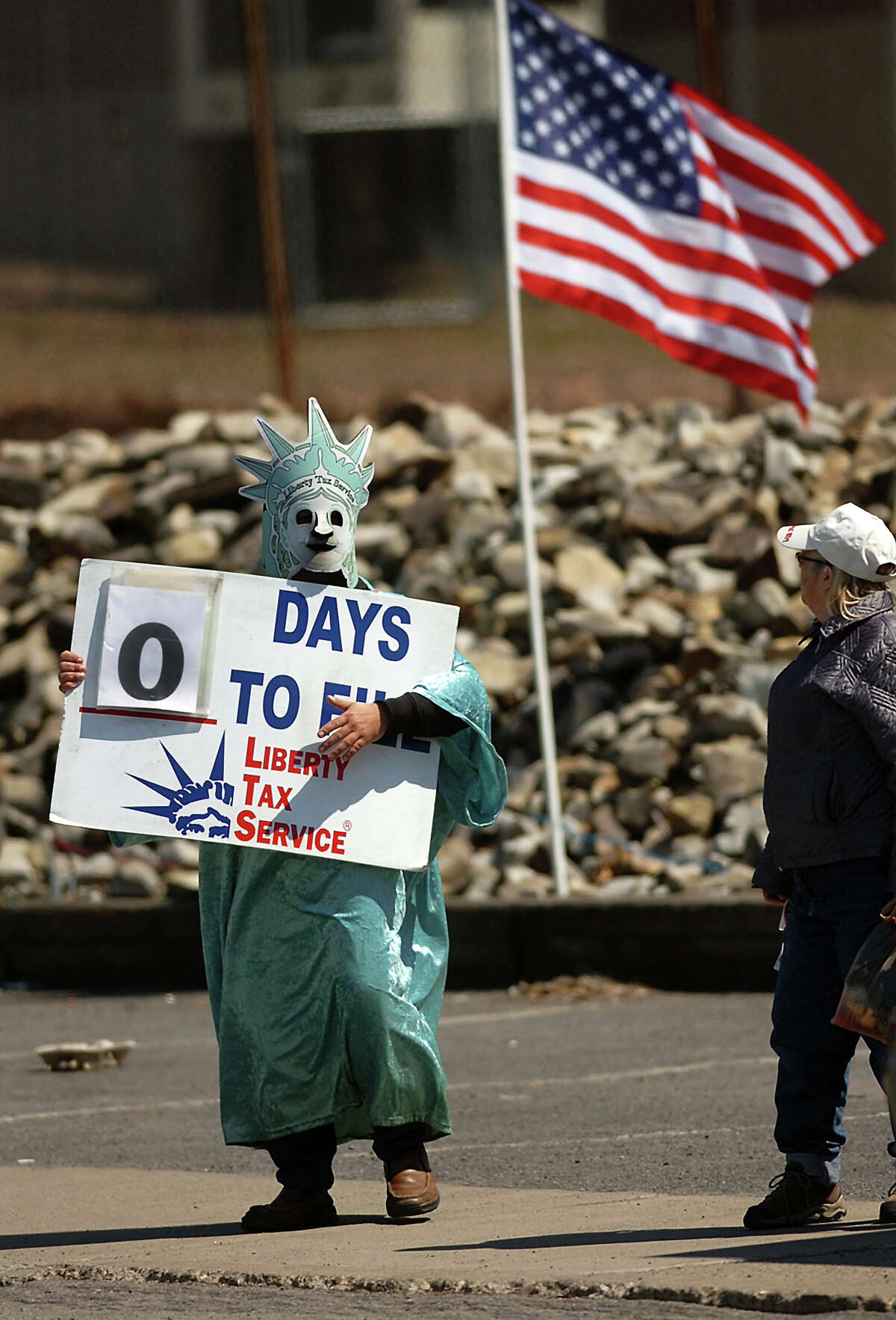 Dressed as The Statue of Liberty, Philip Luongo of Scranton, Pa. waves to passing motorists on S. Webster Avenue in Scranton, Pennsylvania on Monday, April 15, 2013. Monday was the last day for Americans to file their tax forms. (AP photo / The Scranton Times-Tribune, Butch Comegys) (AP Photo/Scranton Times & Tribune, ) WILKES BARRE TIMES-LEADER OUT; MANDATORY CREDIT