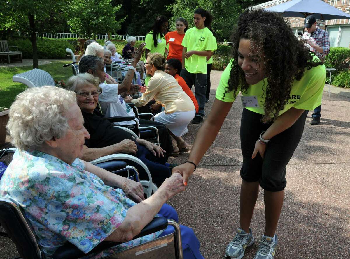 Hamden Health Care is hosting Care Camp for Hamden High School students interested in working in nursing and elder care. Student Erin Harpe right introduces herself to resident Vera Muthersbaugh left. Photo by Mara Lavitt/New Haven Register 8/9/11