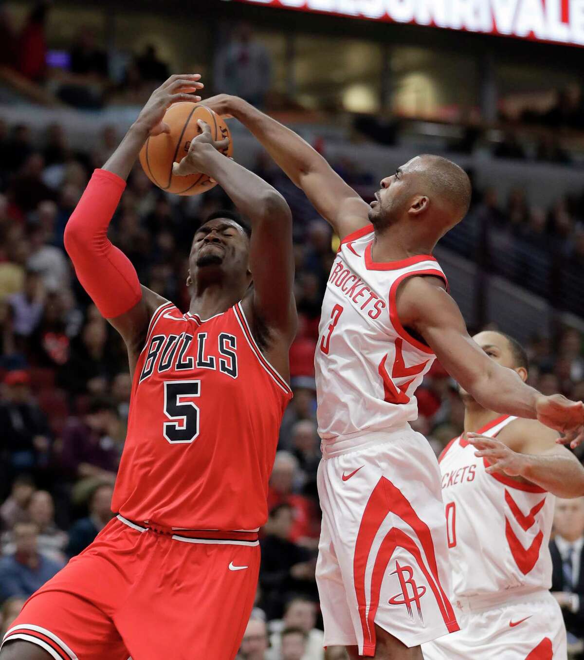 Houston Rockets' Chris Paul, front right, blocks the shot of Chicago Bulls' Bobby Portis, left, during the second half of an NBA basketball game Monday, Jan. 8, 2018, in Chicago. (AP Photo/Charles Rex Arbogast)