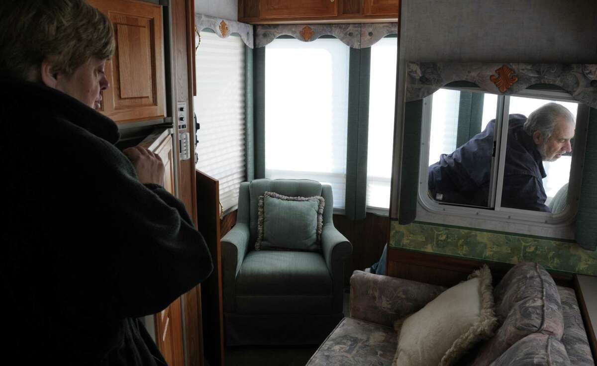 Marion and Louis Nero of Cheshire visit their RV being kept in Westbrook. They are not happy that the state is suddenly enforcing camping limits at the state shoreline parks. Photo by Mara Lavitt/New Haven Register 11/11/11