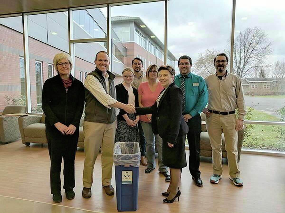 Representatives of Mid Michigan Community College receive a grant from Apex Clean Energy that will be used to improve environmental and clean energy initiatives on campus. (Photo provided)