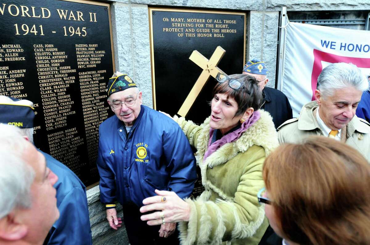 Congresswoman Rosa DeLauro (center right) talks with Derby Mayor Anthony Staffieri (bottom left), Joseph Berube, Sr. (center left), American Legion Post 50 Adjutant and State Rep. Linda Gentile (bottom right) after a press conference announcing the Protect Veterans' Memorials Act at the Woodbridge Avenue Honor Roll and War Memorial in Ansonia on 1/12/2012. At far right is Jamie Cohen, president of the Valley Community Foundation, who announced the Veterans Memorial Plaques Restoration Fund. Photo by Arnold Gold/New Haven Register AG0435A