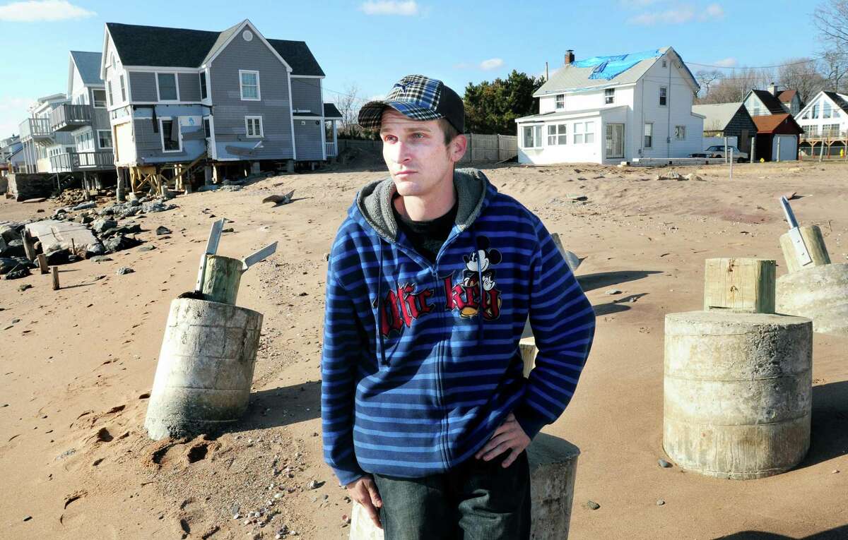 Shawn Hopkinson of East Haven sits on a concrete piling where a house once stood at Cosey Beach in East Haven on 2/7/2012. Hopkinson set up the relief organization, People Helping People, at Cosey Beach after Hurricane Irene. Photo by Arnold Gold/New Haven Register AG0438C