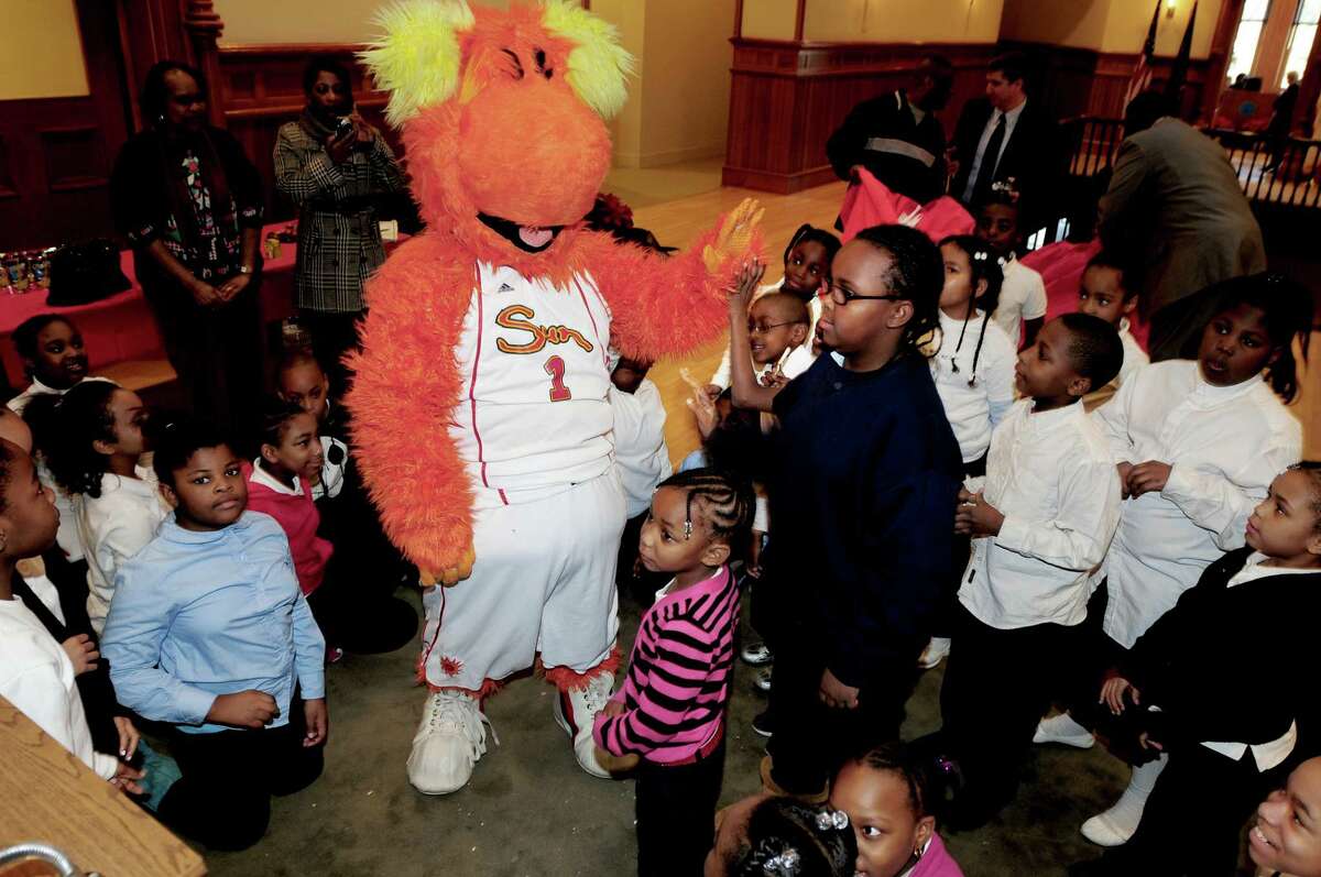 Blaze, the Connecticut Sun women's basketball team mascot, greets students from Lincoln Bassett School at City Hall in New Haven on 12/16/2010. Students were given gifts and also met the head coach, Mike Thibault. Photo by Arnold Gold/New Haven Register AG0396B