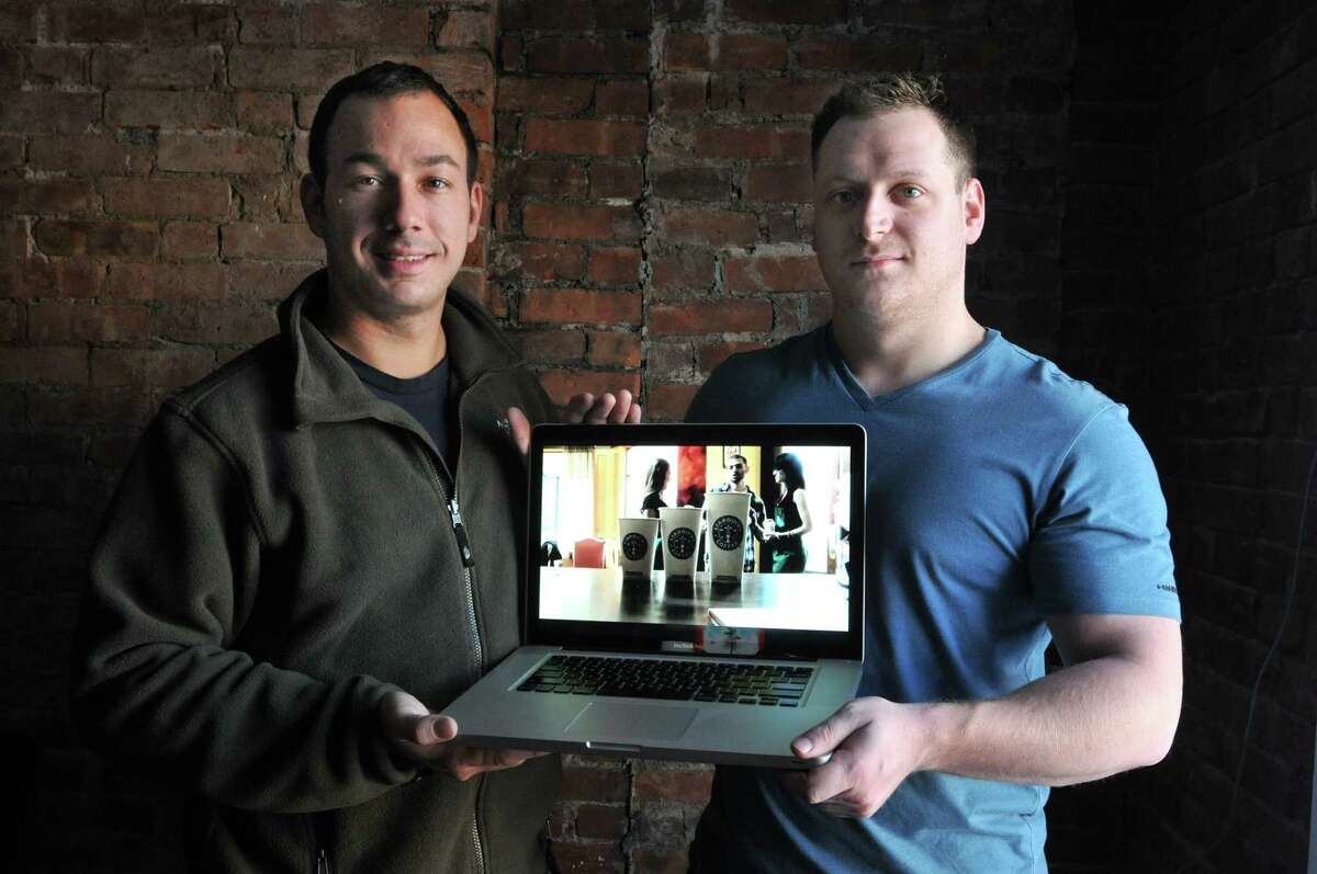 New Haven-- Pete Sena, right, founder of Digital Surgeons and David Salinas co-founder produced a video that has gone viral on the internet. It can be found at www.addicted2coffee.com. They are shown at their Digital Surgeons offices in New Haven. Photo by Peter Casolino/New Haven Register 12/17/10 Cas101217