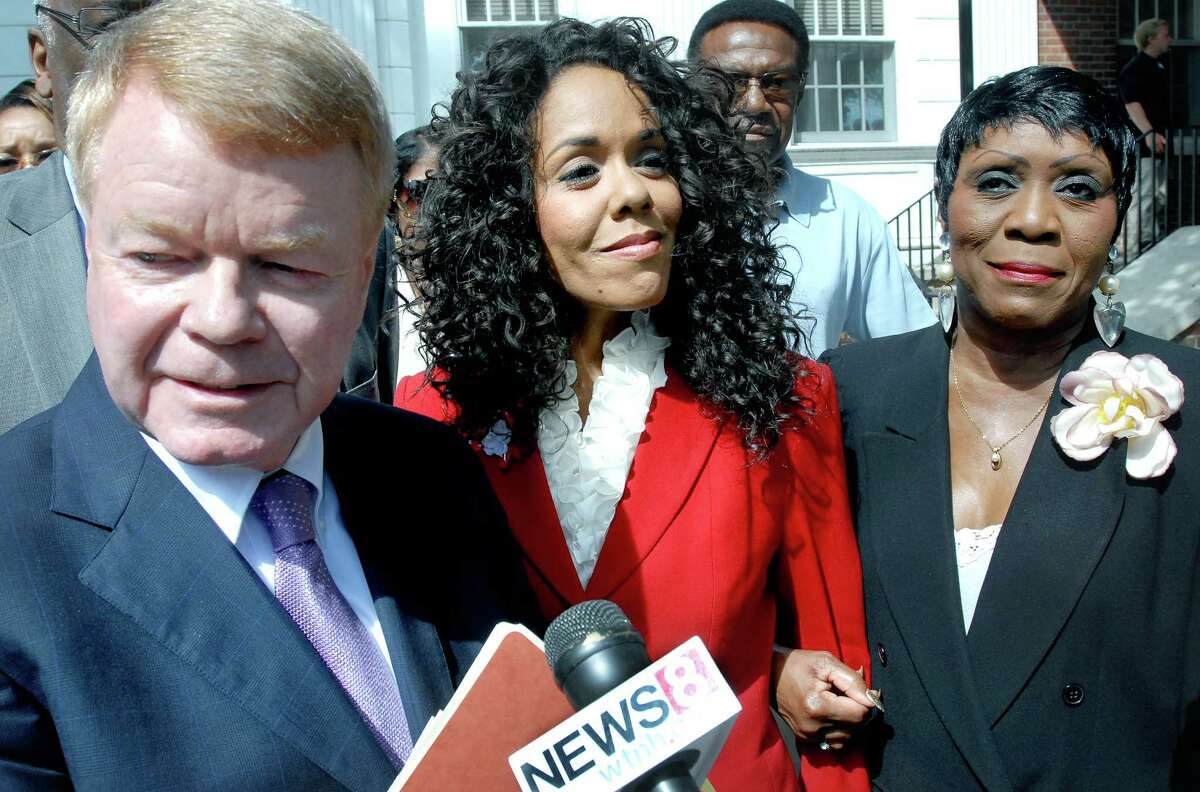 Attorney Hugh Keefe (left) makes a statement to the press concerning former WTNH-TV host Desiree Fontaine (center) after a court appearance on shoplifting charges at Milford Superior Court on 7/27/2010. At right is Carroll Brown, president of the West Haven Black Coalition. Photo by Arnold Gold AG0379D