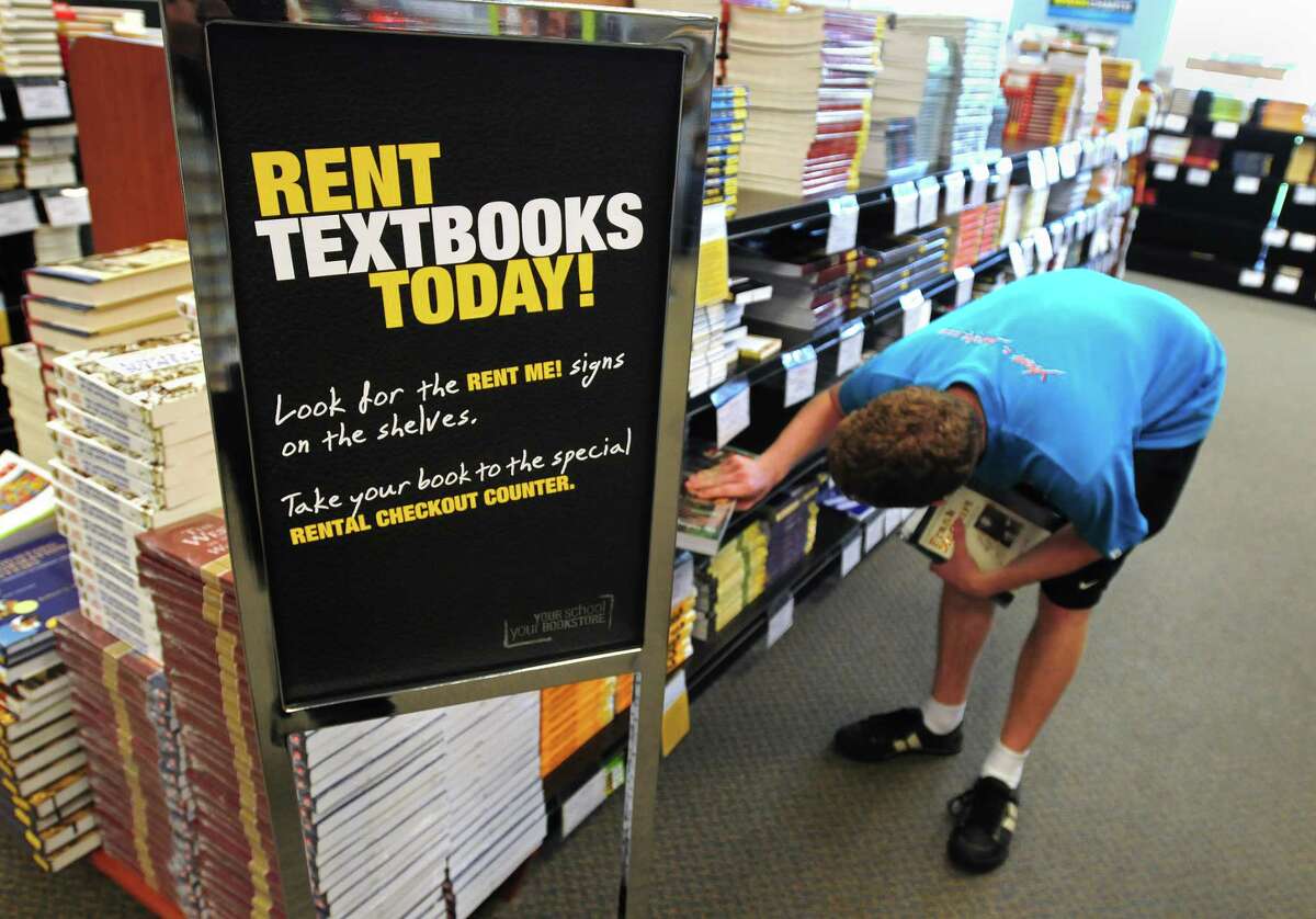 Brad Horrigan | New Haven Register. BH0650. New Haven, Connecticut - 08.18.10: Ryan Kelly, a sophomore from Shelton, looks for a book at the Southern Connecticut State University bookstore Wednesday. Textbook rental is becoming increasingly popular on college campuses.
