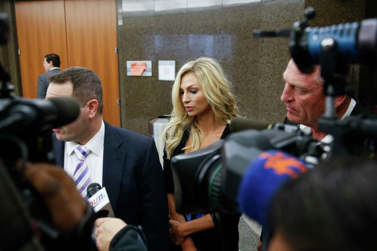 Lindy Lou Layman stands with her defense attorney, Justin Keiter, after making an appearance in court Tuesday, Jan. 9, 2018 in Houston. Layman is accused of destroying at least $300,000 worth of sculptures and original paintings - including two original Andy Warhol works - at the River Oaks home of Houston trial lawyer Anthony Buzbee.