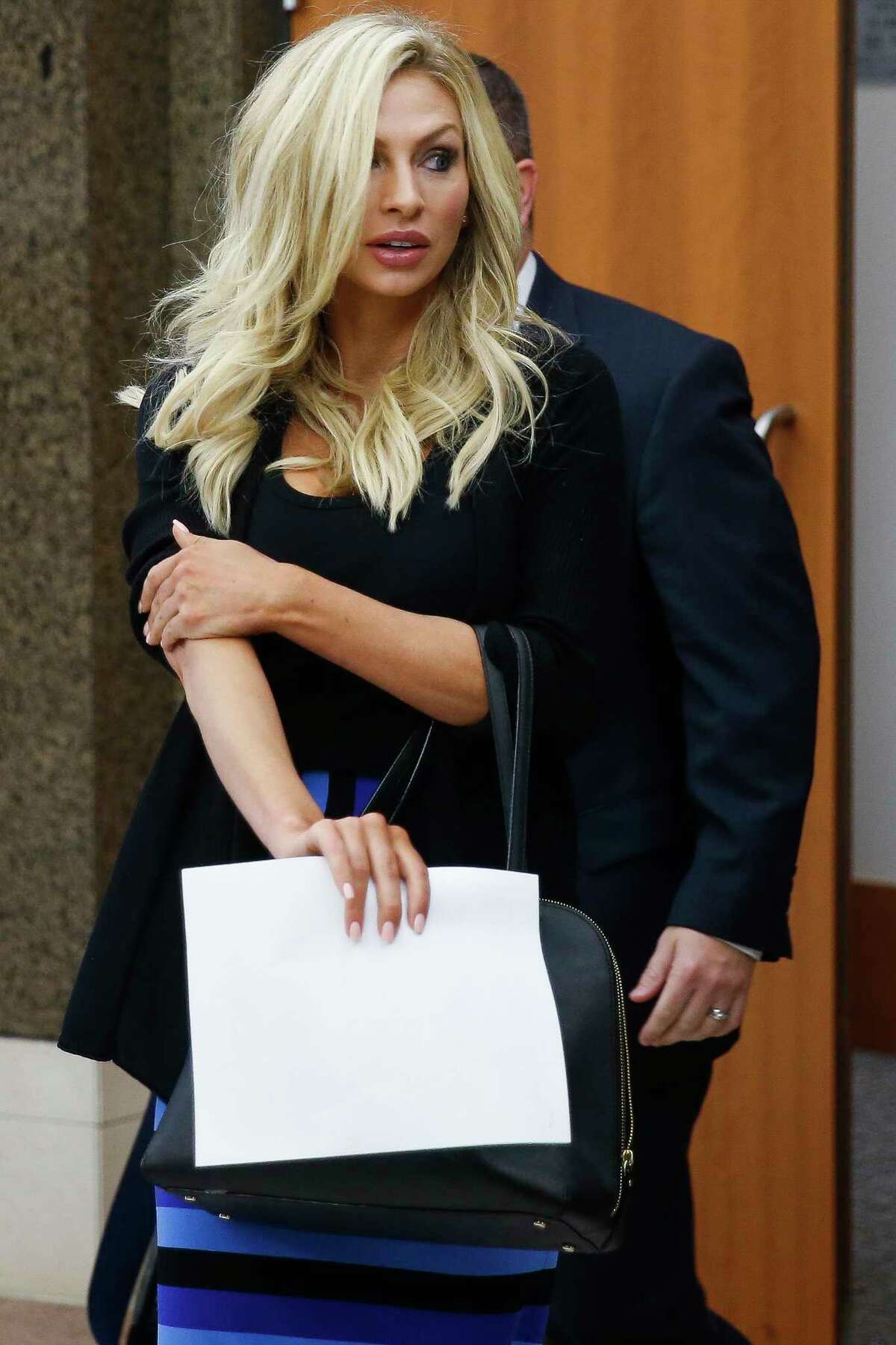 Lindy Lou Layman walks out of court Tuesday, Jan. 9, 2018 in Houston. Layman is accused of destroying at least $300,000 worth of sculptures and original paintings - including two original Andy Warhol works - at the River Oaks home of Houston trial lawyer Anthony Buzbee.