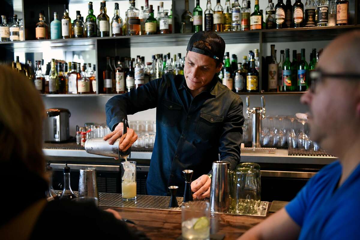Head bartender Carlos Yturria pours a drink at the White Cap cocktail bar in San Francisco, Calif., on Saturday January 6, 2018.