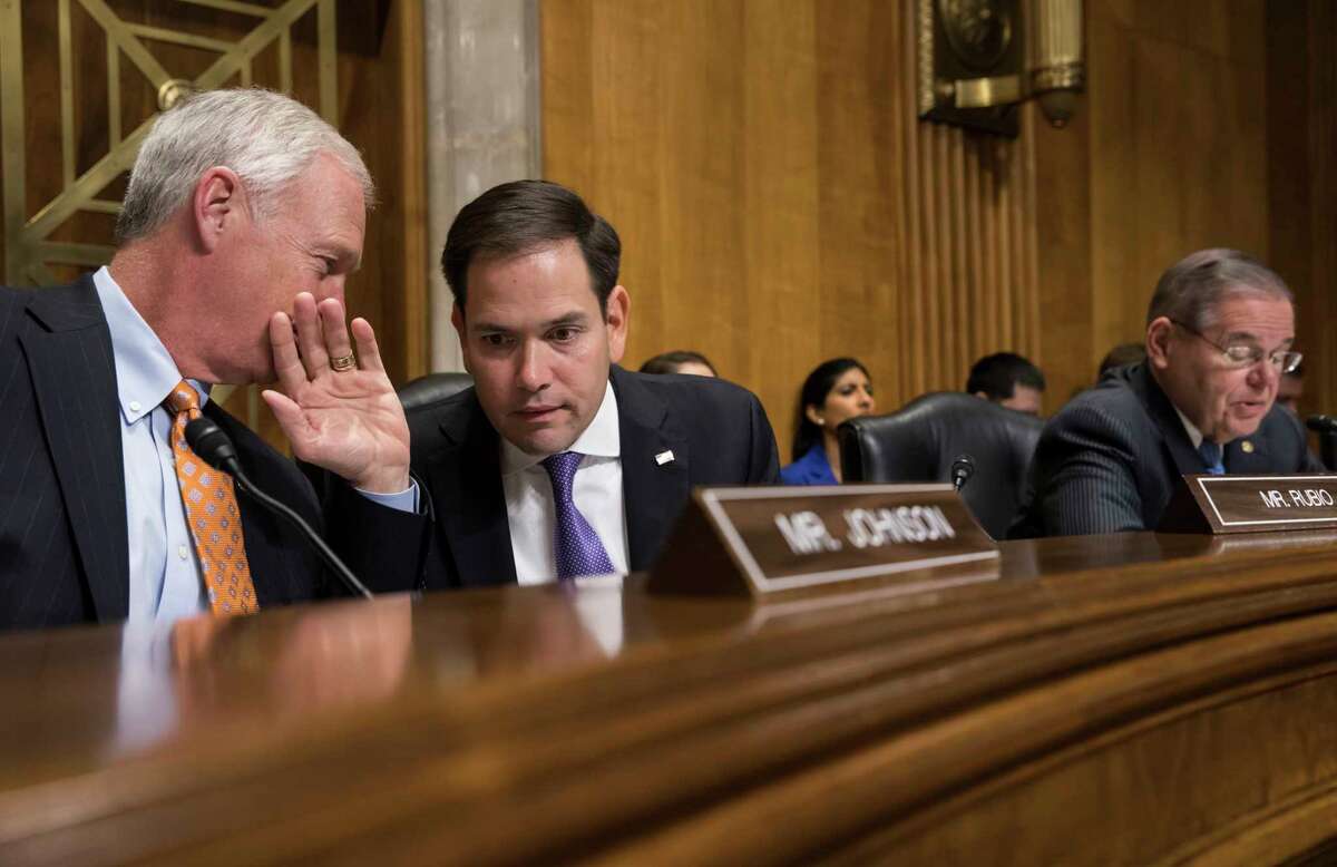 Sen. Marco Rubio, R-Fla., center, confers with Sen. Ron Johnson, R-Wisc., left. Rubio's website indicated that sanctions may be imposed against the Venezuelan oil company PDVSA. NEXT: See the world's largest oil refineries. 