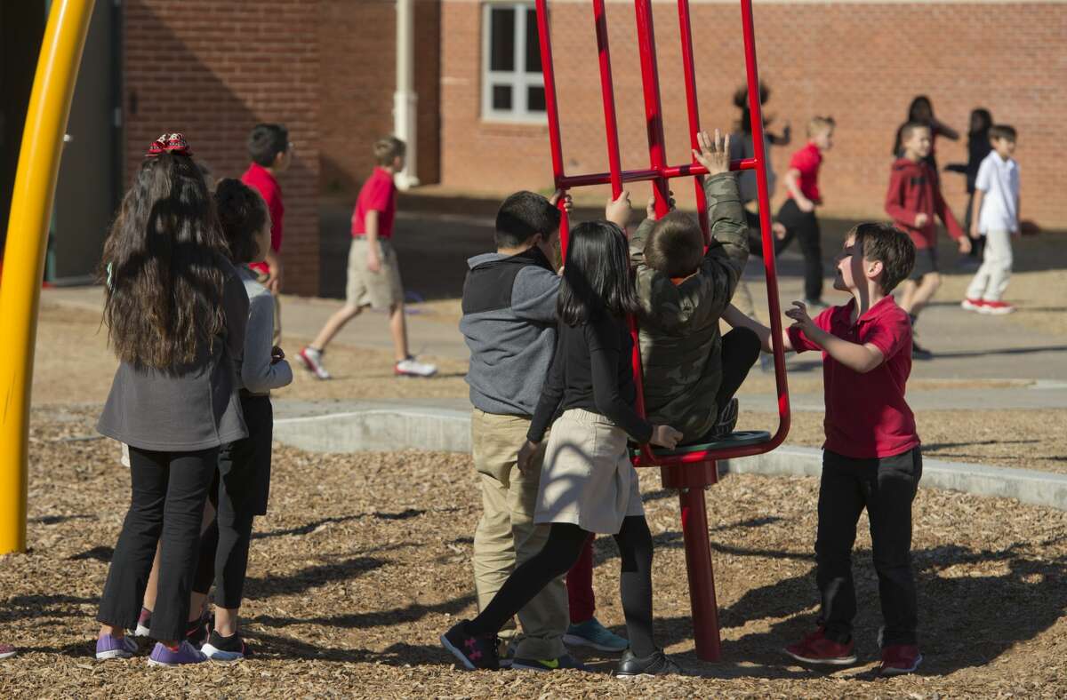 Students at Bowie Elementary play on playground equipment and run around 12/19/17. Tim Fischer/Reporter-Telegram