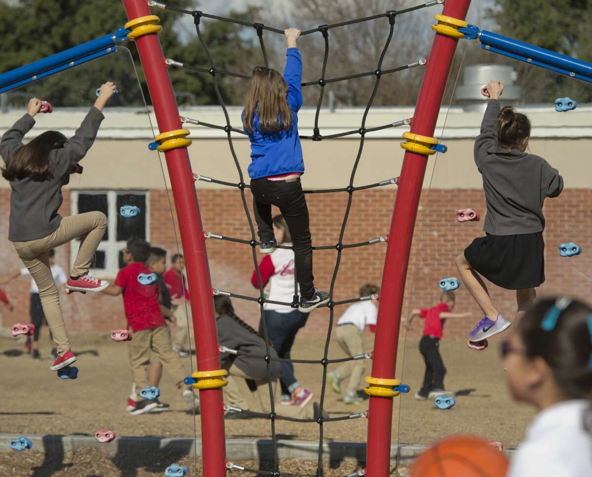 Students at Bowie Elementary play on playground equipment and run around 12/19/17. Tim Fischer/Reporter-Telegram