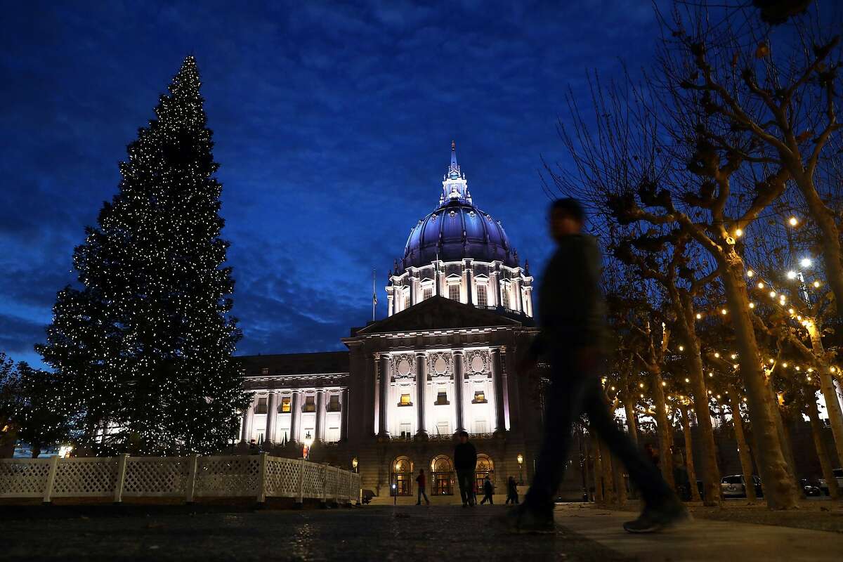 San Francisco City Hall is lit with white and blue lights on New Year's Eve in San Francisco, Calif., on Sunday, December 31, 2017.