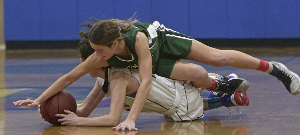New Fairfield’s Grace Ware (14) and new Milford’s Gillian Boss (21) battle for a loose ball in the consolation game .