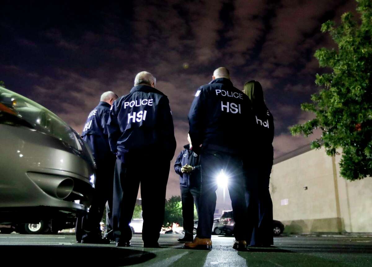 U.S. Immigration and Customs Enforcement agents gather before serving a employment audit notice at a 7-Eleven convenience store Wednesday, Jan. 10, 2018, in Los Angeles. Agents said they targeted about 100 7-Eleven stores nationwide Wednesday to open employment audits and interview workers. (AP Photo/Chris Carlson)
