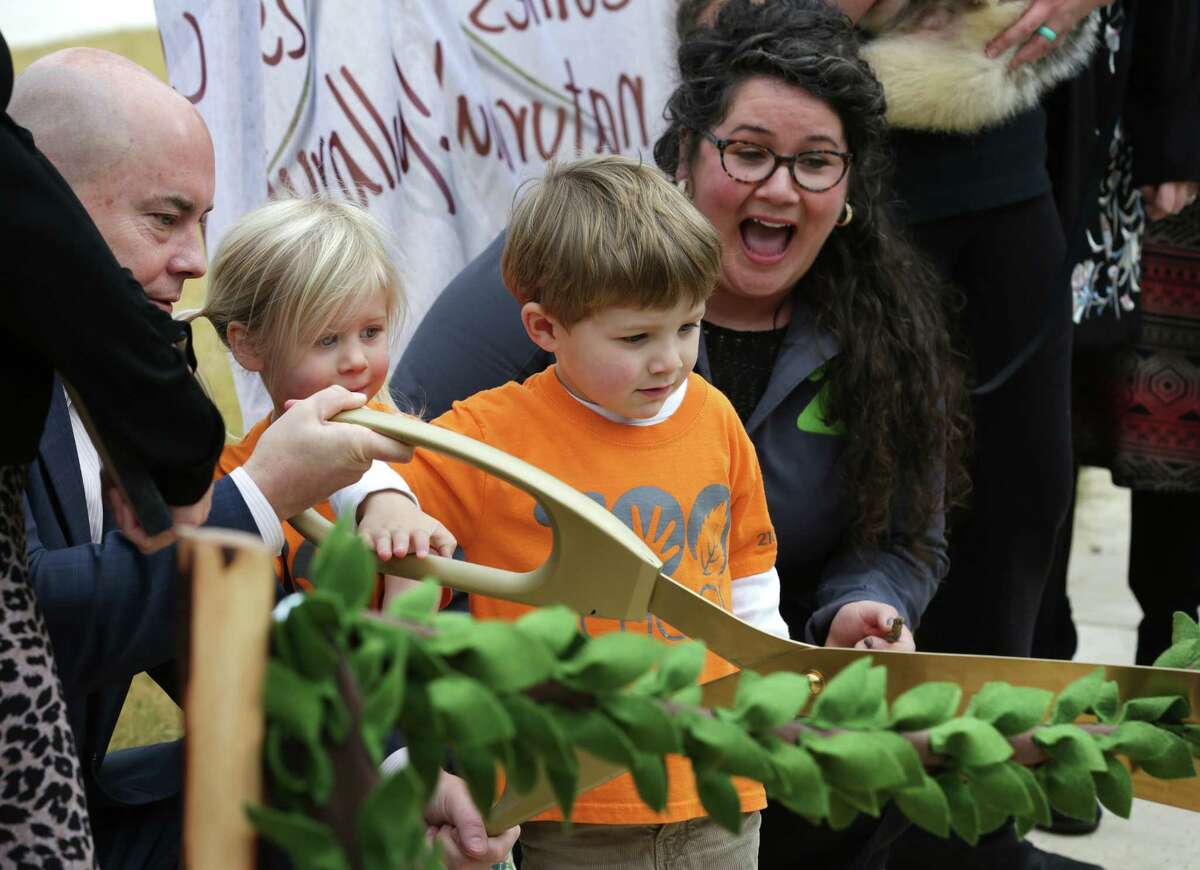 San Antonio Zoo CEO Tim Morrow, left, helps students Leora Latimer, second from left, and Will Russell, with teacher Sarah Mortati, right, cut the "ribbon" as The San Antonio Zoo officially opens the Will Smith Zoo School that fosters an appreciation of animals and plants with a nature-based curriculum, outside activities and an exploration of the zoom, on Wednesday, Jan. 10, 2018.